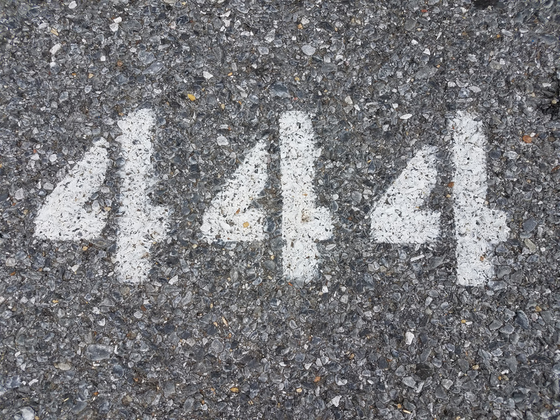 the number 444 painted on black asphalt